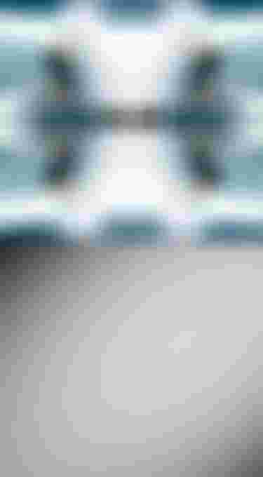 A mirrored image of a kitesurfer riding through waves with "DLAB" text at the center; bottom half is empty gray space.