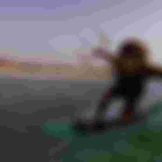 Kitesurfer Matchu skillfully rides a wave on the Duotone Whip SLS Board