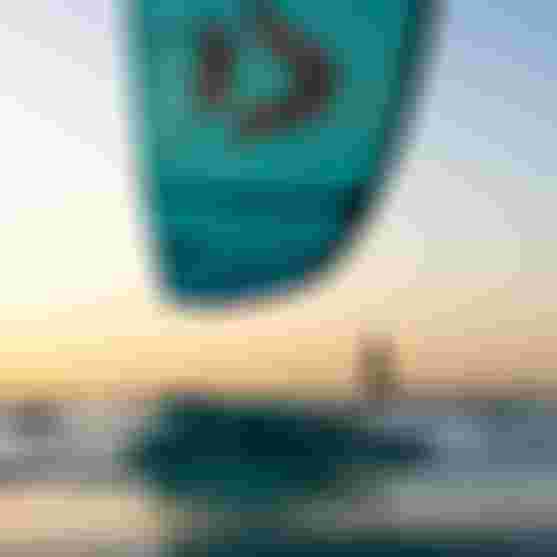 Reno Romeu kiteboarding on calm water at sunset, with a Juice D/LAB and a Foil.