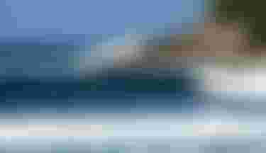 Finn Spencer riding a wave on Guadeloupe with Crush SLS