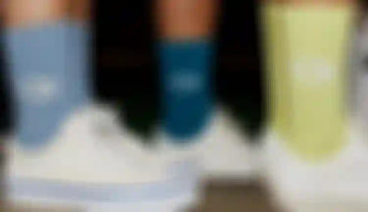 Four people wearing colourful Duotone socks standing next to each other
