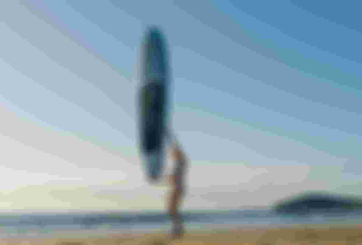 Duotone Rider holding SUP in one hand