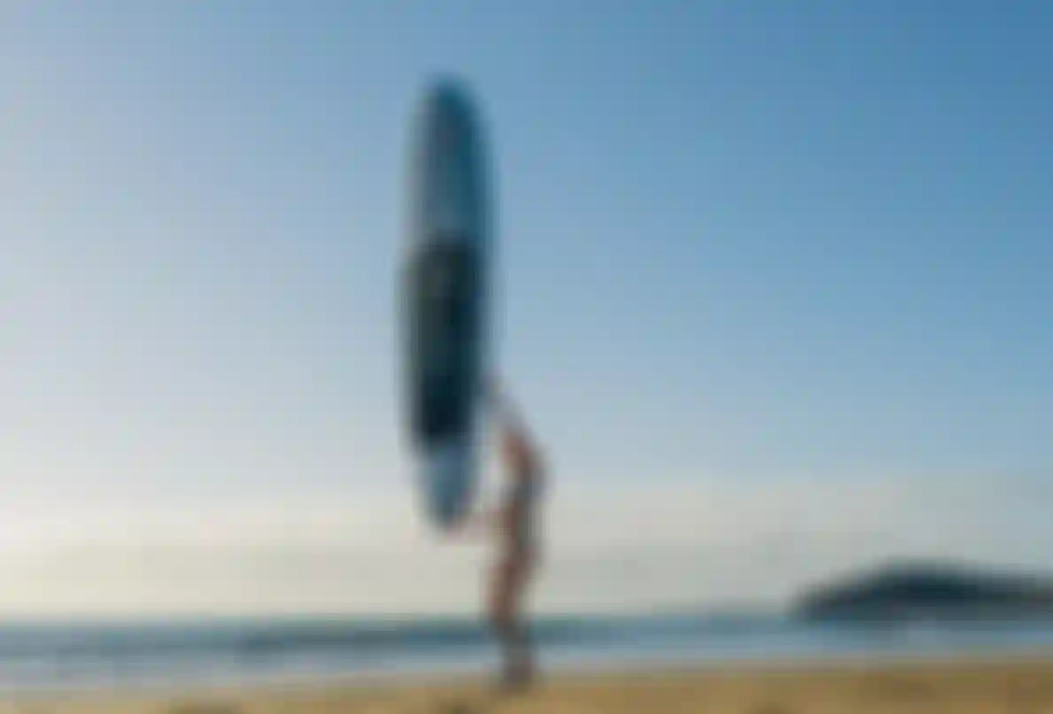 Duotone Rider holding SUP in one hand