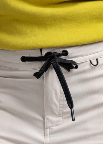 Comfortable fit closure with press button, zip with drawcord and elastic in the back