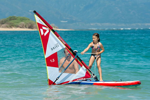 Duotone Drive Cloth freeride sail during windsurfing in a shallow ocean lagoon with sandy beach and mountains