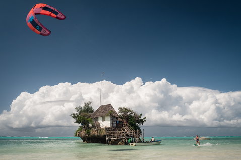 Duotone Dice LEI kite during kitesurfing over a tropical ocean lagoon near Zanzibar