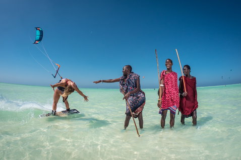 Duotone Dice LEI kite during kitesurfing over tropical ocean shallows with sandy beach