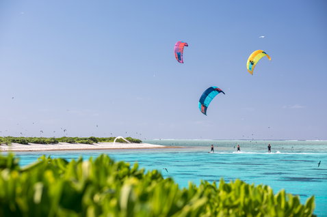 Duotone Dice LEI kite during kitesurfing in a tropical lagoon with sandy island and shallow turquoise water