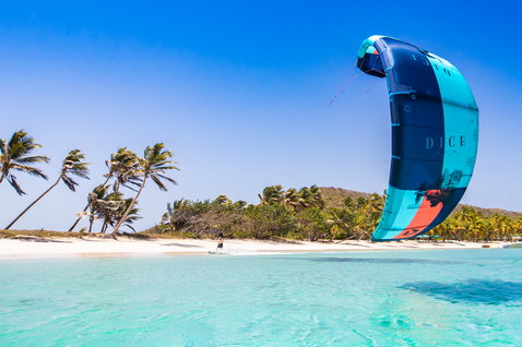 Duotone Dice LEI kite 13m during kitesurfing at a tropical beach with shallow turquoise lagoon