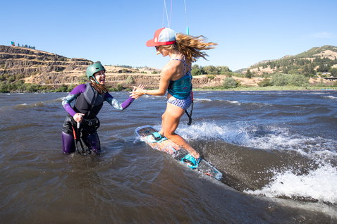 Duotone Gonzales twin-tip kiteboard during kitesurfing in a river gorge with rocky cliffs