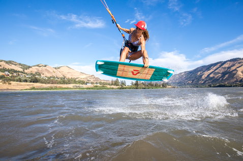 Duotone Gonzales twin-tip kiteboard during kitesurfing in a river gorge with mountains