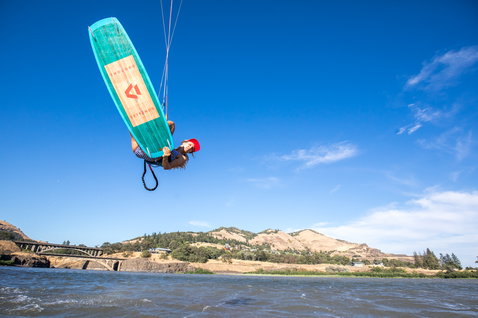 Duotone Gonzales twin-tip kiteboard during kitesurfing on a river at Columbia River Gorge with bridge