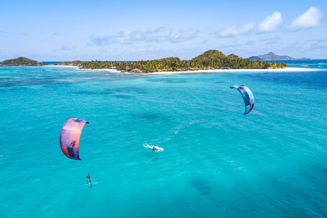 Duotone Neo LEI kite during kitesurfing over a tropical ocean lagoon with island backdrop