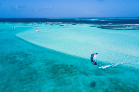 Duotone Neo LEI kite during wave riding in a tropical ocean lagoon