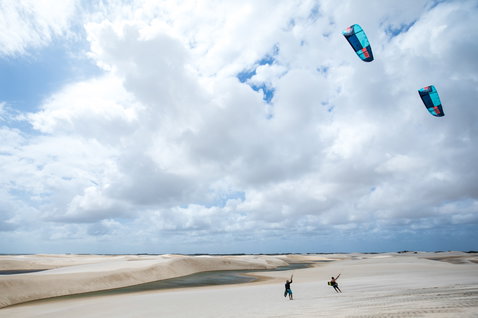 Duotone Evo LEI kite during kitesurfing at sand dunes with lagoon in coastal desert