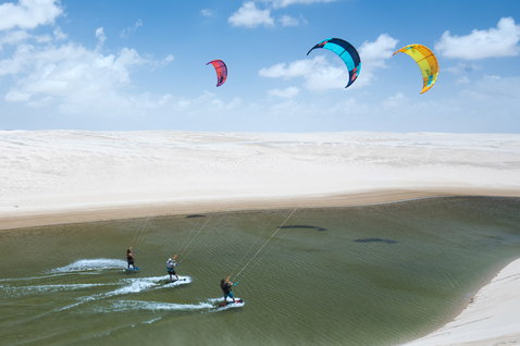 Duotone Evo LEI kite during kitesurfing at a desert lagoon with white sand dunes