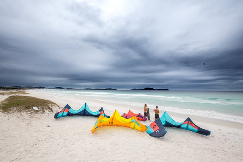 Duotone Evo LEI kite during kitesurfing on an ocean beach with white sand
