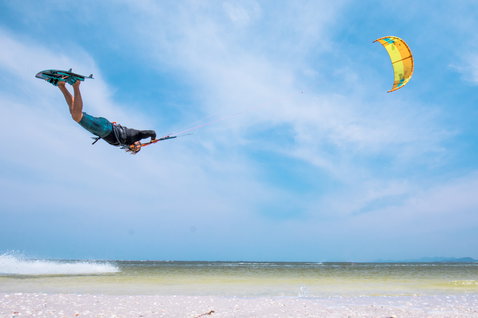 Duotone Evo LEI kite during kitesurfing at a tropical ocean beach in shallow water