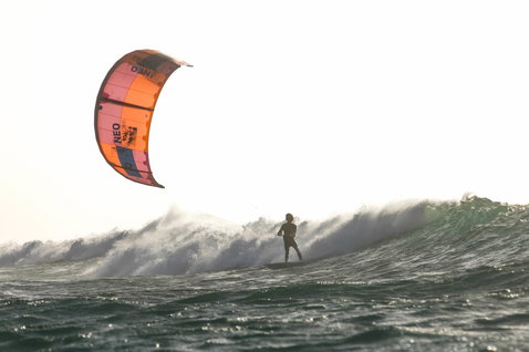 Duotone Neo LEI kite during wave riding on an ocean beach with open water waves