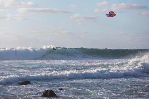 Duotone Neo LEI kite during wave riding at an ocean beach with breaking waves