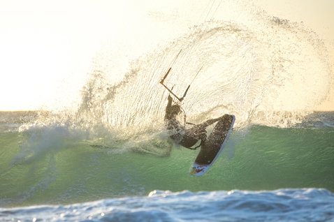 Duotone Pro Voke CSC wave kiteboard lors du surf de vagues sur une plage océanique