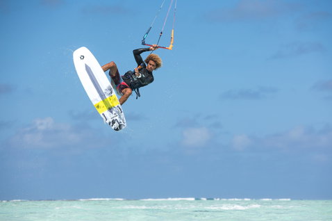 Duotone Pro Whip CSC tabla de kitesurf de olas durante el surf de olas en una playa tropical