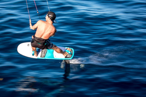 Planche de kite foil lors de foiling sur l'océan ouvert aux eaux bleu profond