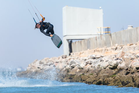 Duotone Click Bar Quad Control control bar during kitesurfing at a coastal rocky jetty