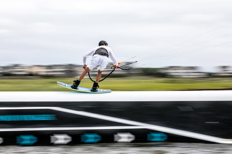 Duotone Gambler wake-style kiteboard durante il wakestyle al kite park con rails e ostacoli kicker