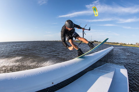 Duotone Vegas LEI kite during wakestyle on a flat water lagoon with a distant shoreline