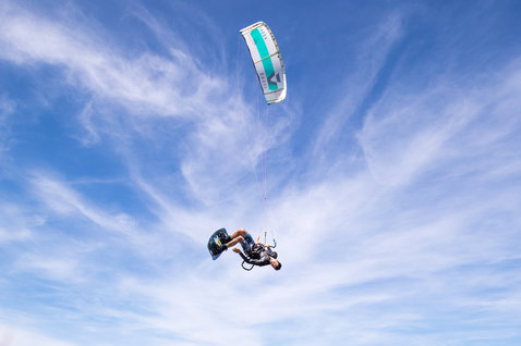 Duotone Vegas LEI kite during kitesurfing in open sky in light blue and white