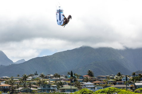 Duotone Pro Voke 2020 kite surfboard during kitesurfing at a tropical coastal location with mountain backdrop