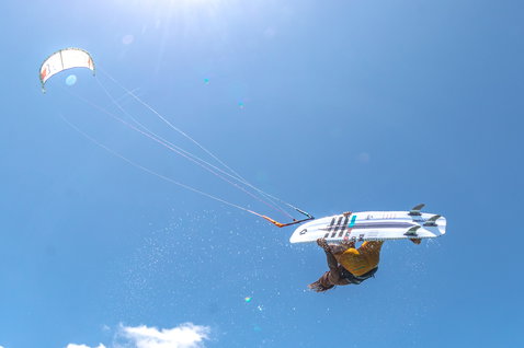 Duotone Pro Voke strapless freestyle kiteboard during kitesurfing above the ocean