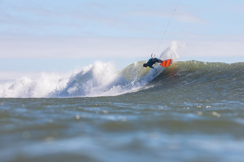 Duotone Wam wave kiteboard during wave riding in open ocean at wave break