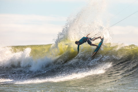 Duotone Wam wave kiteboard during wave riding on ocean beach