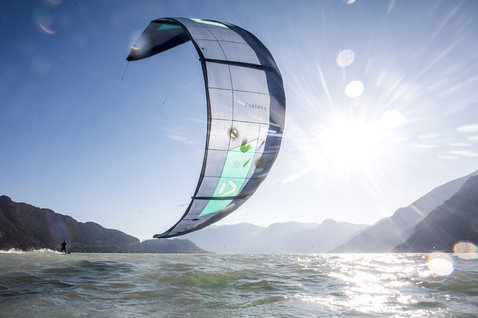 Duotone Evo LEI Kite beim Kitesurfen an einem Alpensee mit Bergpanorama