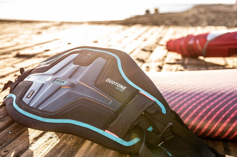 Duotone Radium TS seat harness during windsurfing on a beach boardwalk