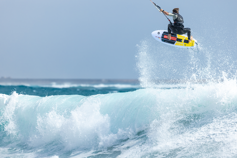 Duotone Fish D/LAB directional kiteboard during kitesurfing at the ocean beach