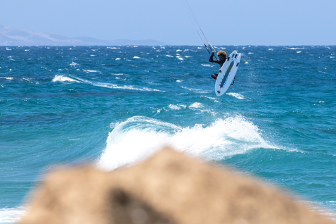 Duotone Fish D/LAB directional kiteboard during kitesurfing at the ocean beach