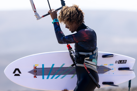 Duotone Fish D/LAB kite surfboard during kitesurfing at an ocean beach