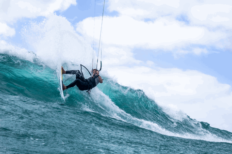 Duotone Whip D/LAB kite surfboard during kitesurfing on an ocean wave