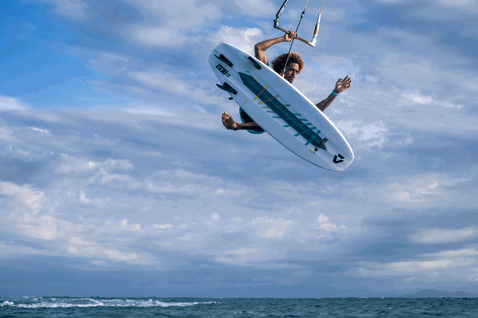 Duotone Whip D/LAB directional kiteboard during kitesurfing at the ocean beach