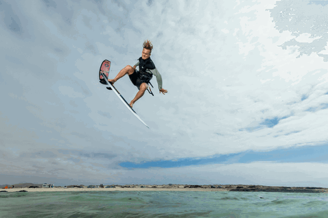 Duotone Kiteboarding Whip D/LAB directional kiteboard during kitesurfing in shallow tropical ocean