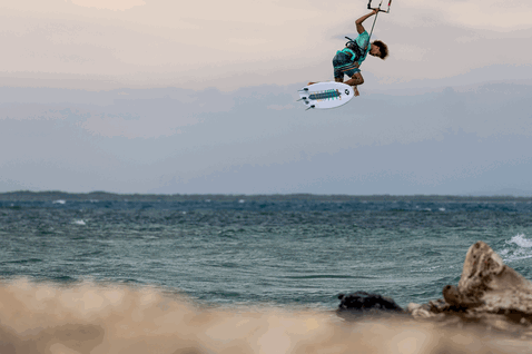 Duotone Whip D/LAB directional kiteboard during kitesurfing at an ocean beach