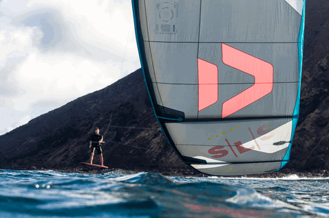 Duotone Rebel SLS LEI kite during kitesurfing in the ocean at a rocky volcanic coastline