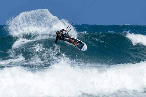 Duotone Fish SLS kite surfboard during kitesurfing at an ocean beach