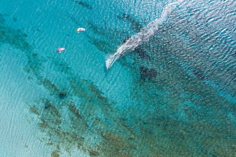 Duotone Dice SLS LEI kite during kitesurfing over tropical shallow reef ocean