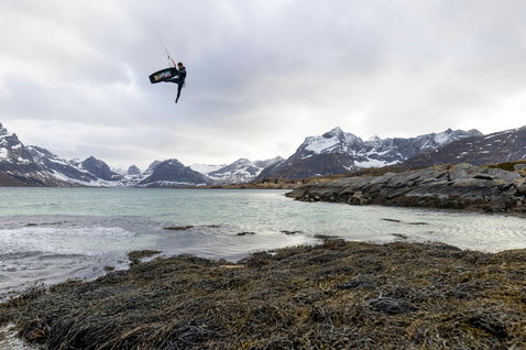 Duotone Jaime SLS twin-tip kiteboard during kitesurfing in a Norwegian fjord with snow-capped mountains
