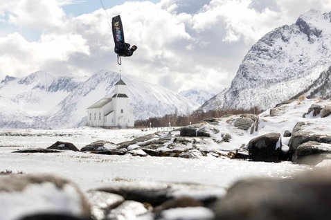 Duotone Jaime SLS twin-tip kiteboard during kitesurfing in an Arctic fjord with snow-covered mountains