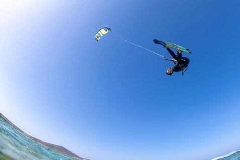 Duotone Select twin-tip kiteboard durante il kitesurf su una spiaggia oceanica